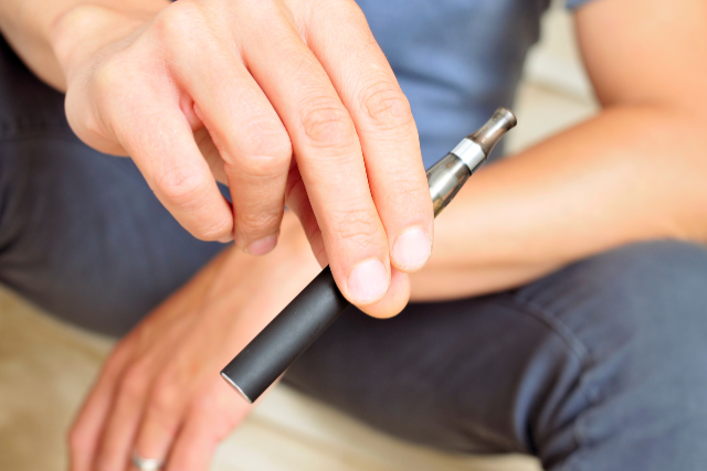 person holding a vape device